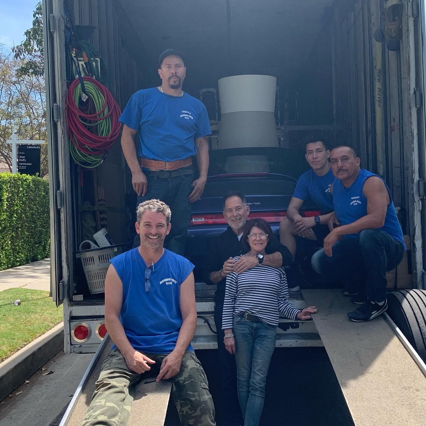 Moving Pro Inc crew with customers after a move