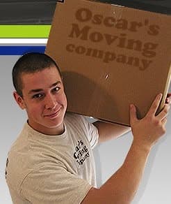 Oscar's Moving Company crew member carrying a moving box