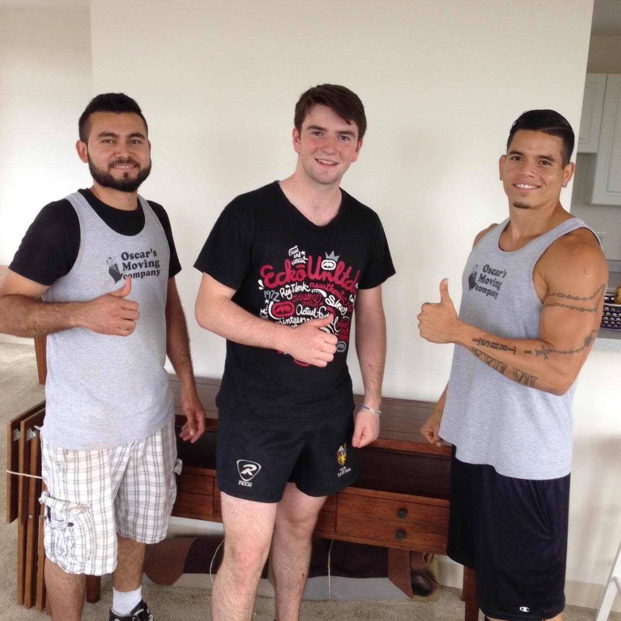 Oscar's Moving Company crew with happy customer after a move