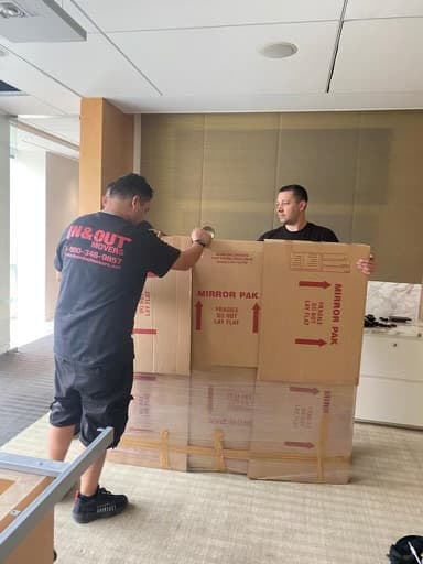 Crew handling fragile items in office