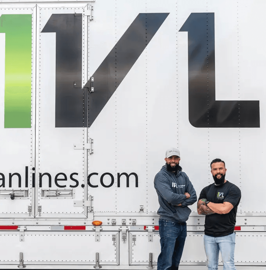 Two crew members by IVL trailer
